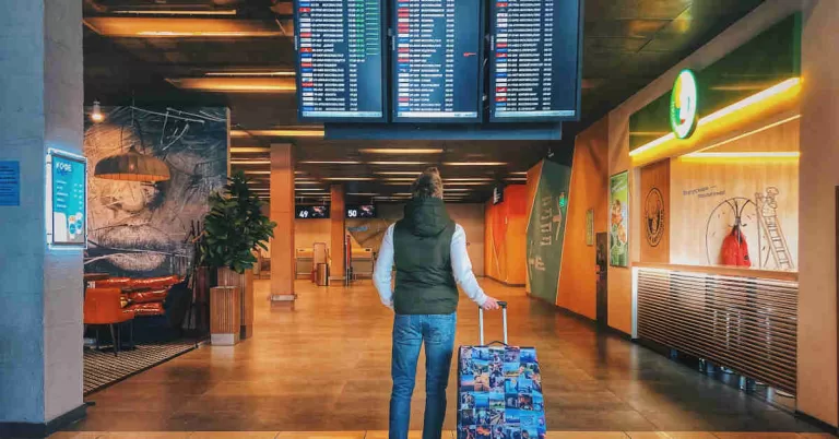Traveler looking at airport flight board