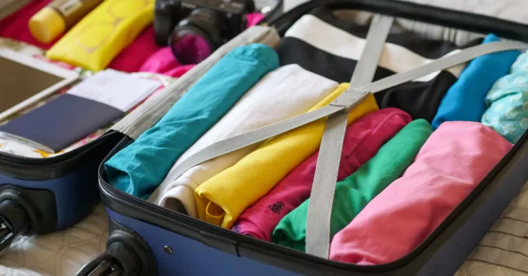 Blue suitcase with folded clothes