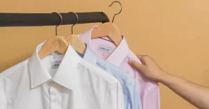 Three business shirts hanging on a garment rack