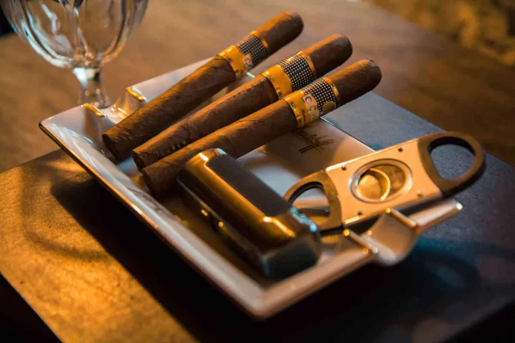 Cigars and cigar cutter on a tray