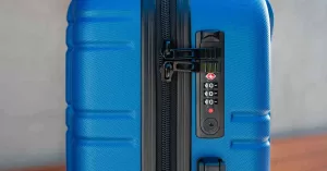 Blue hard side suitcase locked with TSA-approved lock