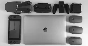 Silver MacBook surrounding black electronic devices