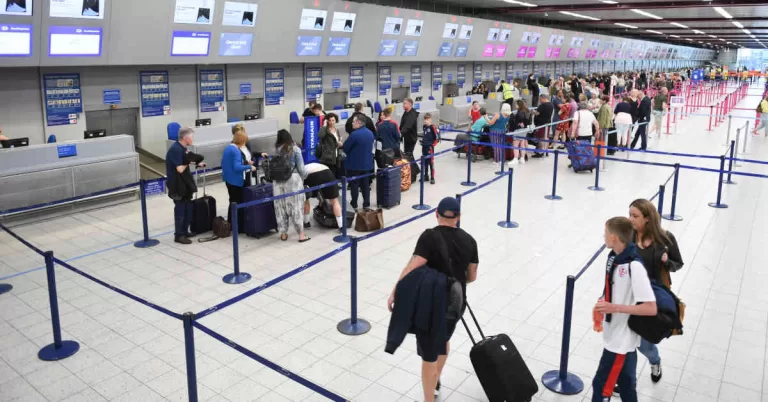 Passengers waiting at airport check-in counter
